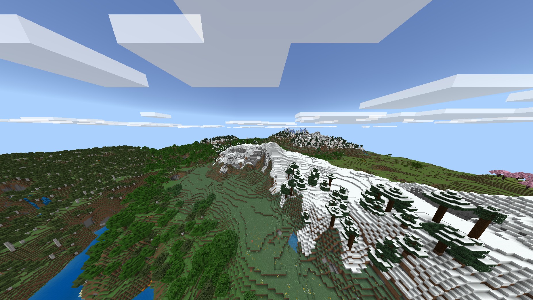 A snowy spruce-covered ridge above green slopes and a river valley.